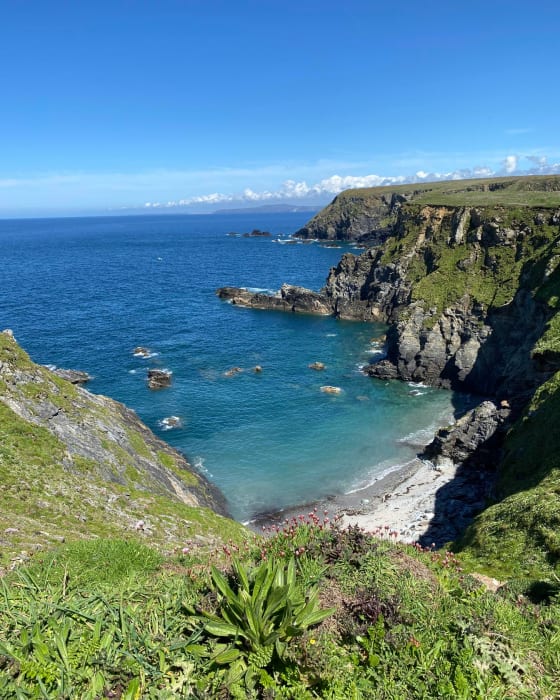 Clear blue sea and white sands viewed from the clifftops on Cornwall's north coast A sandy cove viewed from above