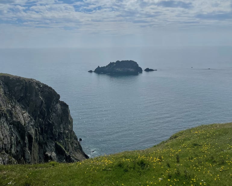 A small island rock in a blue Cornish sea The view from Nare Head